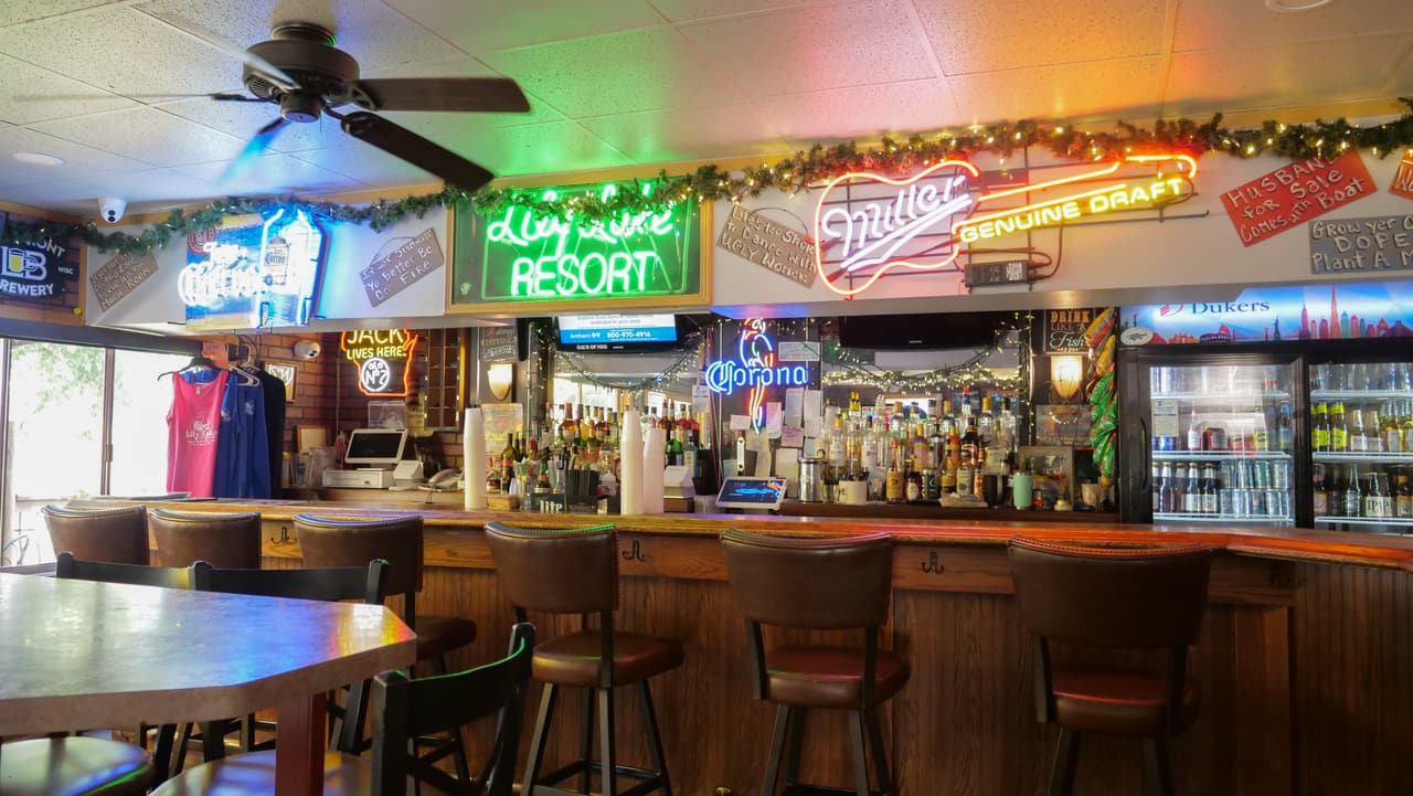 The bar at Lily Lake Resort with taps, neon and stools