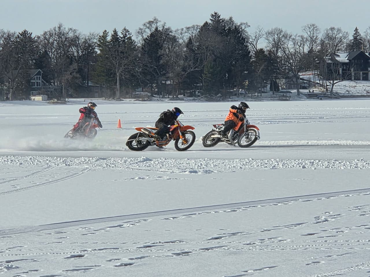 Dirt bikes racing a cone course on frozen Lily Lake