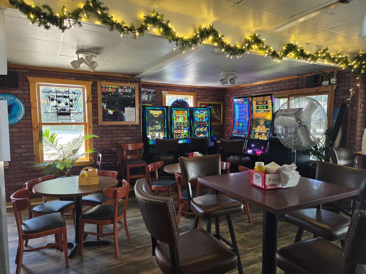 Tables under the garland lights in the bar