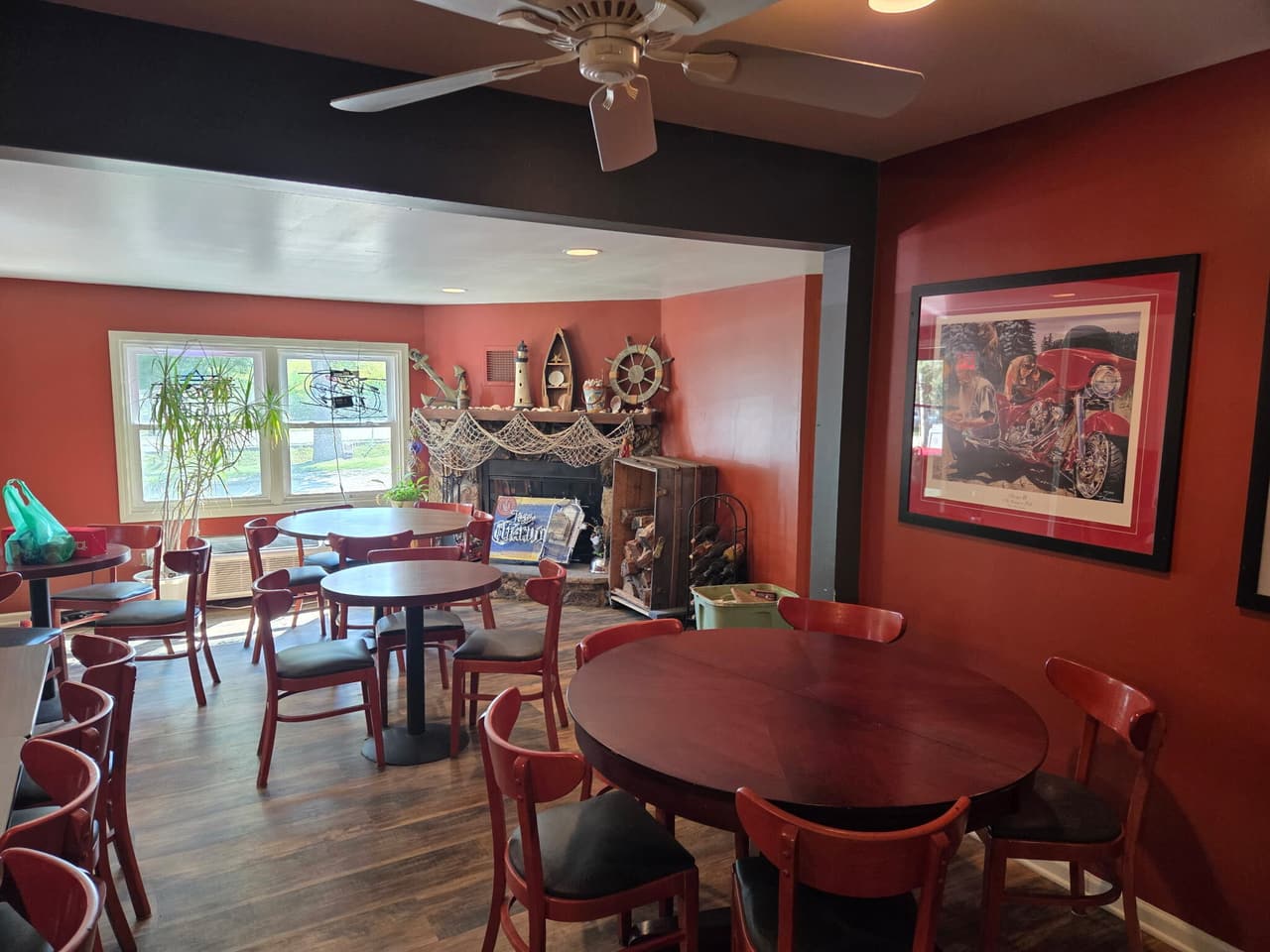 Dining room with round tables and nautical decor by the fireplace