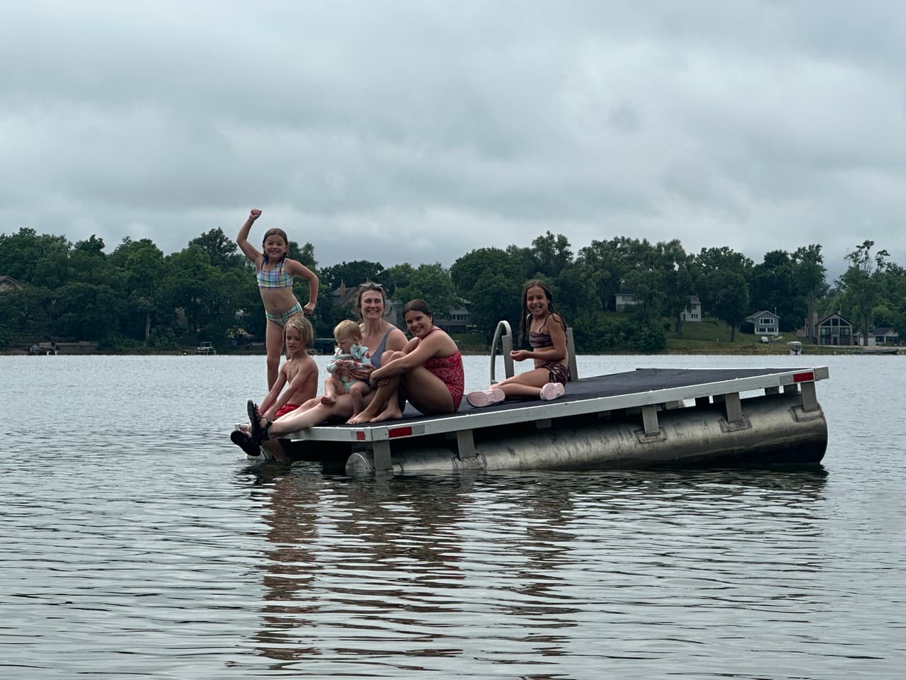 A family on the swim raft out on Lily Lake