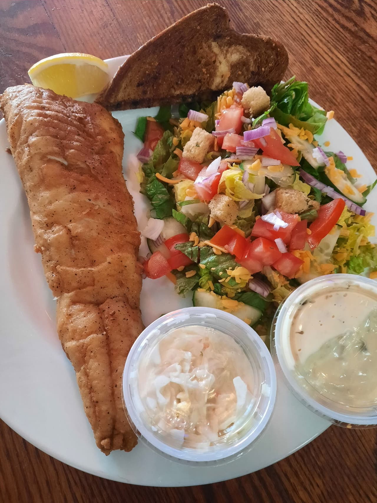 Friday fish fry: baked fish with rye bread, coleslaw, tartar sauce and a side salad