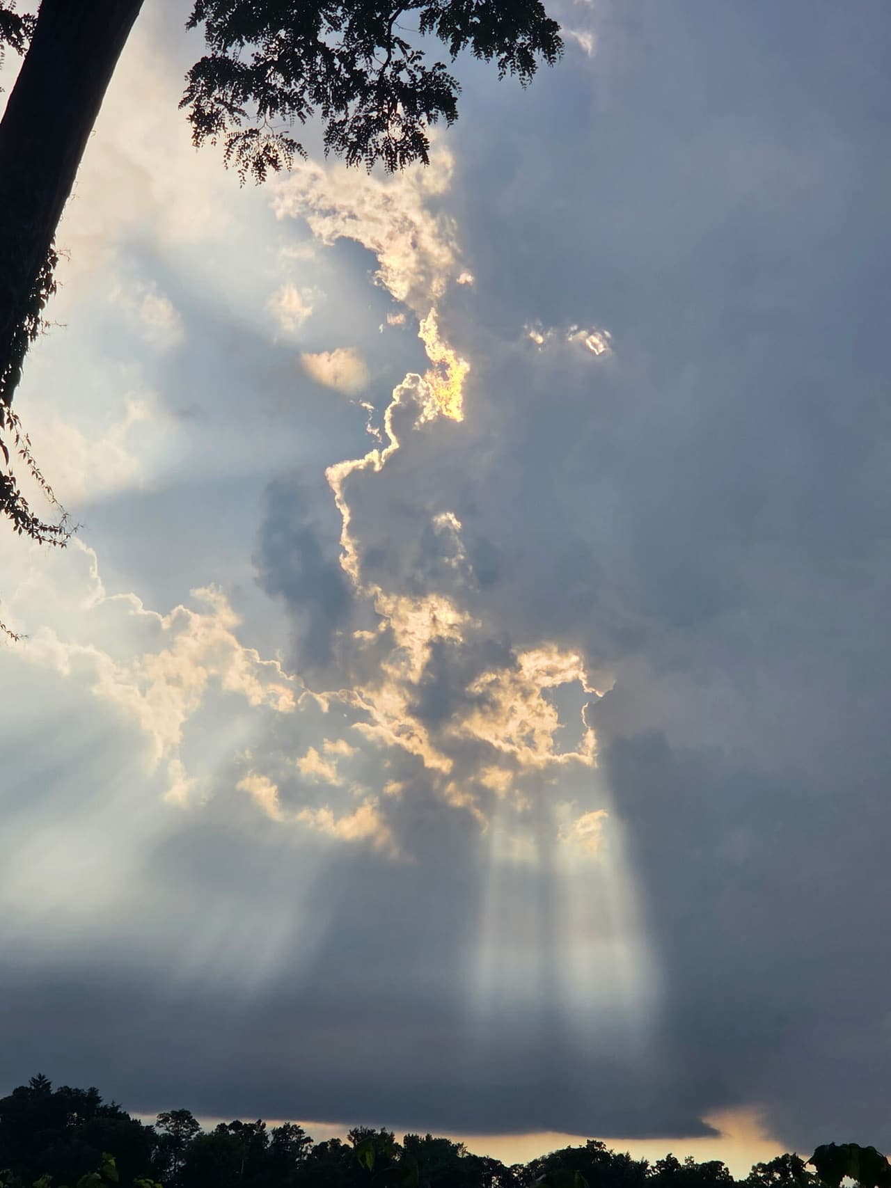 Sunbeams through storm clouds over Lily Lake