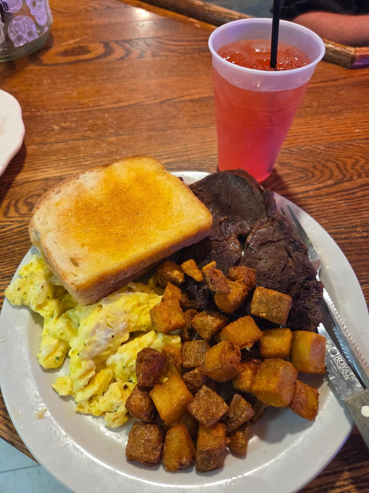 Steak and eggs with toast and breakfast potatoes