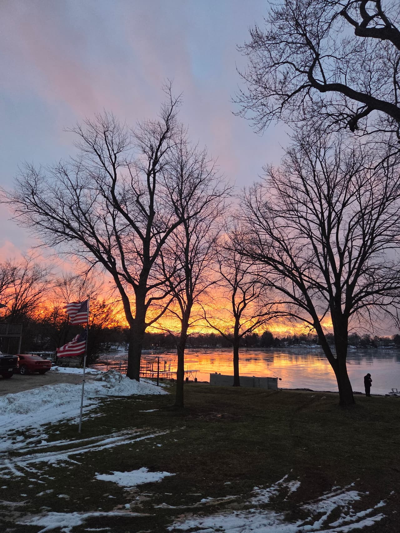 A winter sunset over the snowy shore of Lily Lake