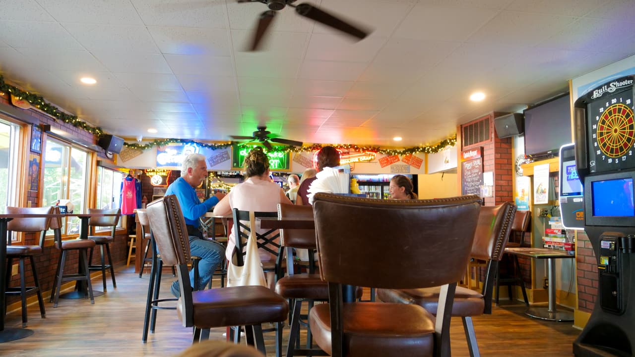 Regulars at tables inside the Lily Lake Resort bar