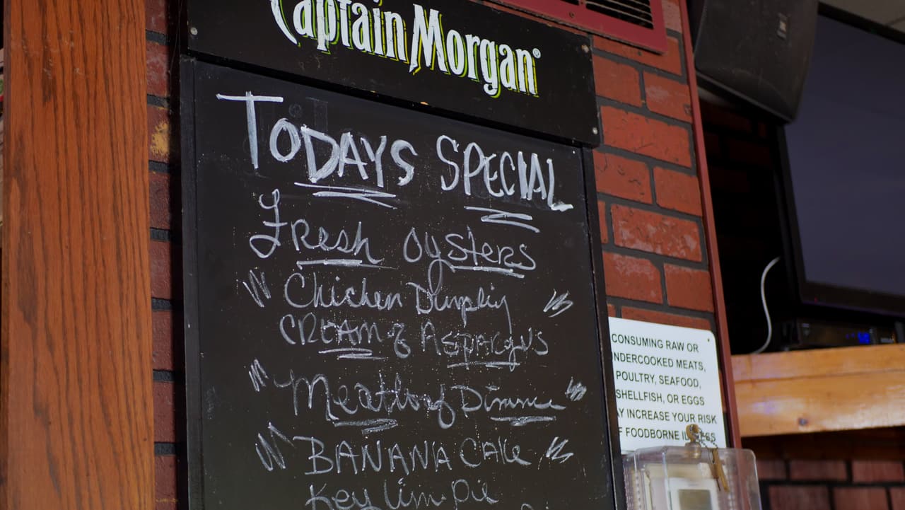 Today's specials chalkboard: fresh oysters, chicken dumpling soup, banana cake