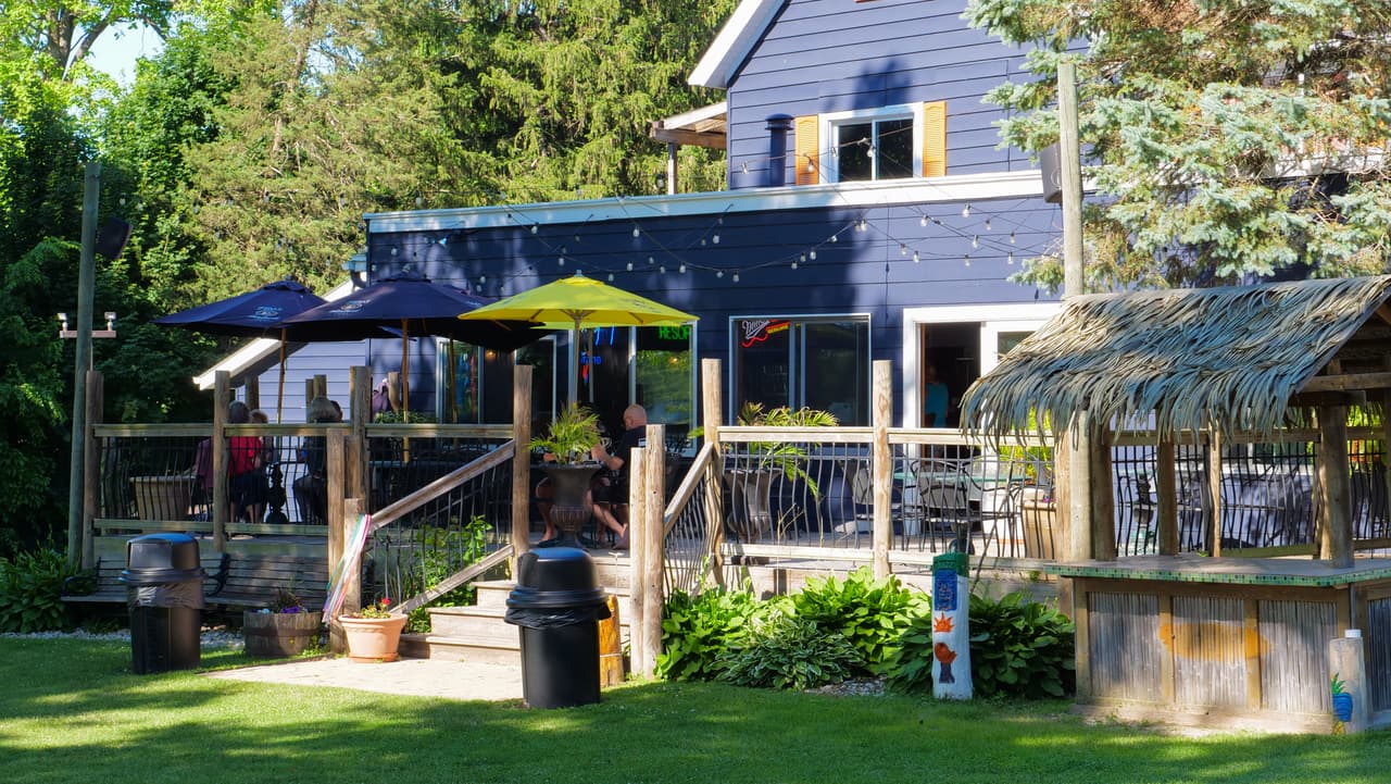 Thatched tiki bar and the deck with yellow umbrellas