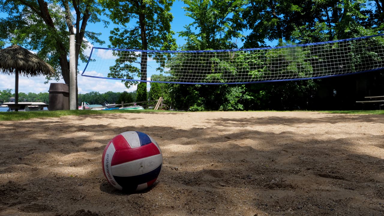 Sand volleyball court with a ball in the sand
